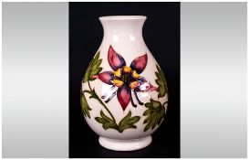 Moorcroft Globual Shaped Vase ' Columbine ' Design on Cream Ground. c.1980-1985. Height 7.75 Inches.