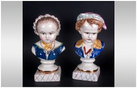 Pair Of Staffordshire Pottery Busts Of a Boy & Girl Wearing Hats, On Square Bases. 8'' in height.