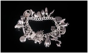 A Vintage Silver Charm Bracelet Loaded with 27 Charms. All Marked and of Good Quality. 121.3 Grams.