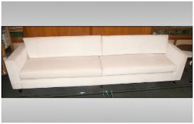 Extremely Large Contemporary Lounge Settee, covered in an ivory coloured material, with two large