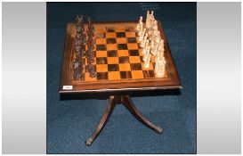 Small Mahogany Pedestal Table, The Square Top With Marked Out Chess Board. Together With Resin Chess