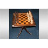 Small Mahogany Pedestal Table, The Square Top With Marked Out Chess Board. Together With Resin Chess