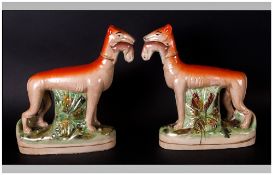 Pair of Pottery Figures of Grey Hounds Holding Rabbits In Their Mouths. Size 10 Inches High, 10