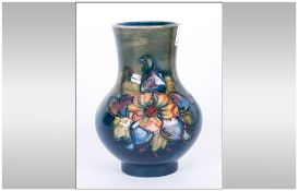 Moorcroft Small Tubelined Globular Shaped Vase 'Orchids' design on green/blue ground. Stands 4.25