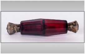 Victorian Ruby Glass Double Ended Scent Bottle, facetted cut body with silver embossed tops with