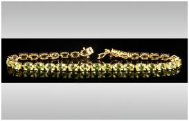 Peridot Tennis Bracelet, oval cut peridots totalling 15cts set in gold vermeil and silver in a