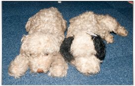 Two Early 20tH Century Blonde/Gold Recumbent Plush Dogs  1 With Studded Back, The Other With Zip