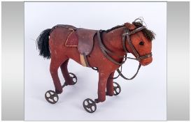 Early 20th Century Felt Pull Along Donkey, Raised On Four Wheels, Straw Filled. Most Probably