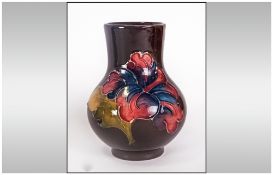 Moorcroft Small Vase, Early Version of Hibiscus Design on Chocolate Brown Ground. Stands 4'' in