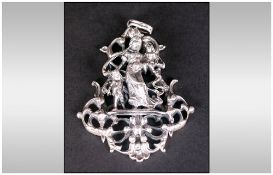 Large Silver Figural Pendant, showing a mother and her two children before an openwork rococo