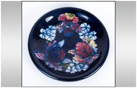 Moorcroft Shallow Footed Dish ' Orchids ' Design on Blue Ground. 8.5 Inches Diameter.