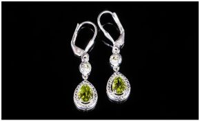 Pair of Peridot Articulated Drop Earrings, pear cut in a millgrain mount, set below a small round