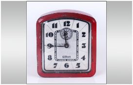 Gilbert Art Deco Alarm Clock, iron red painted tin case, cream face with stylised black numerals,