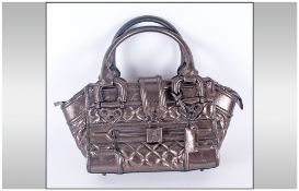 Burberry Designer Handbag with Metallic Quilted Finish and Attached Padlock and Key. Original Dust