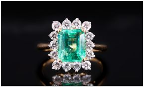 Ladies 18ct Gold Set Emerald & Diamond Cluster Ring, The Central Faceted Natural Emerald Of