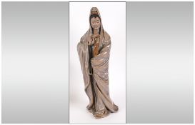Large Chinese Stoneware Glazed Figure Of Queen Yin holding a vase. With A Celadon style glaze.
