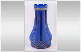 A Large Continental Blue and White Molded Glass Vase, with iron mounts and blown bulbous design.