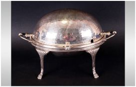 A Silver Plated Rolling Top Bacon Dish with inner liners with a planished decoration supported on