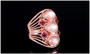 Peach Moonstone and Rhodolite Garnet Ring, three oval cut peach moonstone cabochons, running along