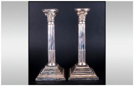 Elizabeth II Impressive Pair Of Silver Corinthian Column Candlesticks raised on square stepped