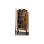 1930's Oak Single Door Display Cabinet With Astral Glazed Door with shaped domed top on turned legs.