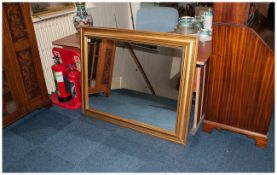 A Large Gilt Framed Mirror with swept frame.