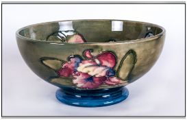 William Moorcroft Signed Footed Bowl ' Orchids ' Pattern on Green and Blue Ground. .