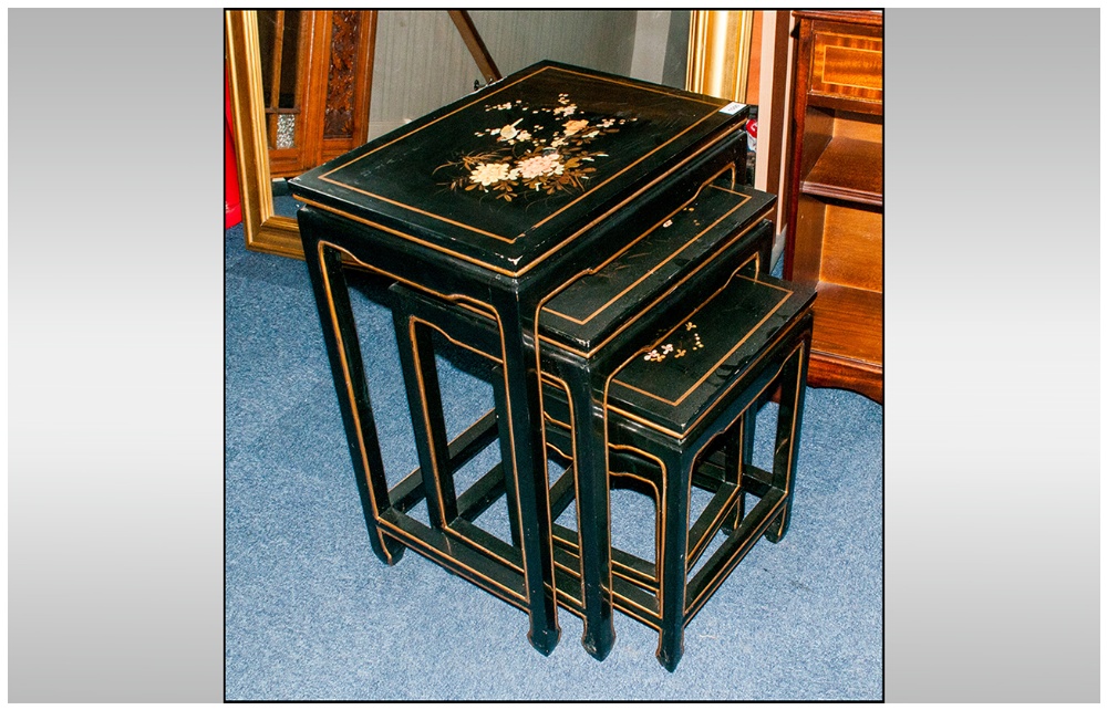 A Nest Of Four Black Lacquered & Decorated Chinese Tables.