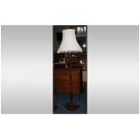 A Carved Stained Beech Art Deco Style Standard Lamp on a square base with carved motifs with tassel