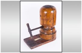 Vintage Wooden Screw Hat Stretcher with large iron handle, with hat size gauge attached to the base.