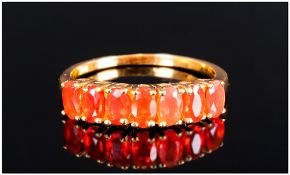 Fire Opal Half Eternity Ring, comprising seven oval cut fire opals, four claw set, closely together,