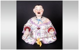 German Porcelain Nodding Buddah Figure In A Sitting Gesture, when the head is touched it rocks on