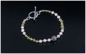 Peridot and Fresh Water Pearl Bracelet, faceted rondelles of peridot interspaced with small silver