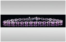 Pink Sapphire Tennis Bracelet, a row of oval cut, rare, pink sapphires, totalling 7cts, set in