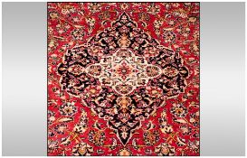 A Large Persian Carpet In The Meshad Style, with a central floral motif with corresponding blue