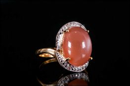 Peach Moonstone Solitaire Ring, an oval cut cabochon of 6.25cts of peach moonstone, with a good show