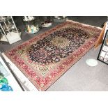 A Turkish Handmade Carpet In The Persian Style with a central Medallion blue ground with floral