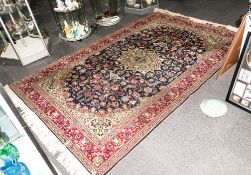 A Turkish Handmade Carpet In The Persian Style with a central Medallion blue ground with floral