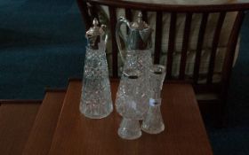 4 Pieces Of Glassware Comprising 2 Claret Jugs And 2 Silver Rimmed Bud Vases