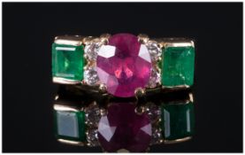 A Fine 18ct Gold Set Ruby & Emerald Ring with diamond spacers. The central faceted ruby of excellent