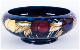 WITHDRAWN // Moorcroft 'Plum and Wisteria' Pattern Bowl, with inverted rim and low foot, a band of