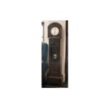 1920s Oak long case clock. Silver dial with Arabic numerals, glazed front, presentation plaque dated