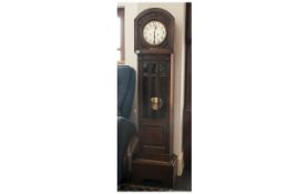 1920s Oak long case clock. Silver dial with Arabic numerals, glazed front, presentation plaque dated