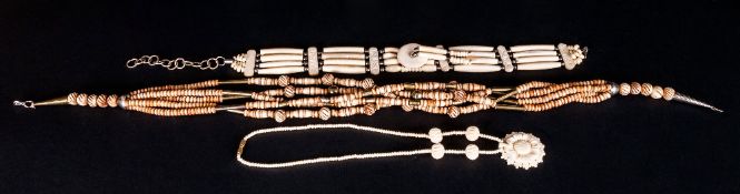 Three Various African Carved Bone Necklaces, comprising a five row, turned and stained bead