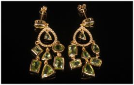 Peridot Pair of Chandelier Earrings, 10.5cts of peridot in a variety of cuts, suspended from gold