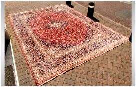 A Large Persian Carpet In The Meshad Style, with a central floral motif with corresponding blue