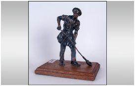 Bronzed Figure Of An Iron Founder Holding A Metal Ladle on wooden base. 12'' in height.