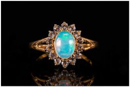 Opal and White Topaz Ring, an oval cut cabochon opal of over 1ct, with a good display of colours,