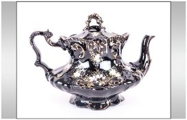 Jackfield Teapot Black ground with gilt & floral design.