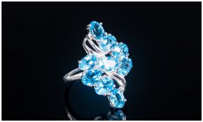 Swiss Blue Topaz Lozenge Cluster Ring, a total of eight oval cut Swiss blue topaz, set in a